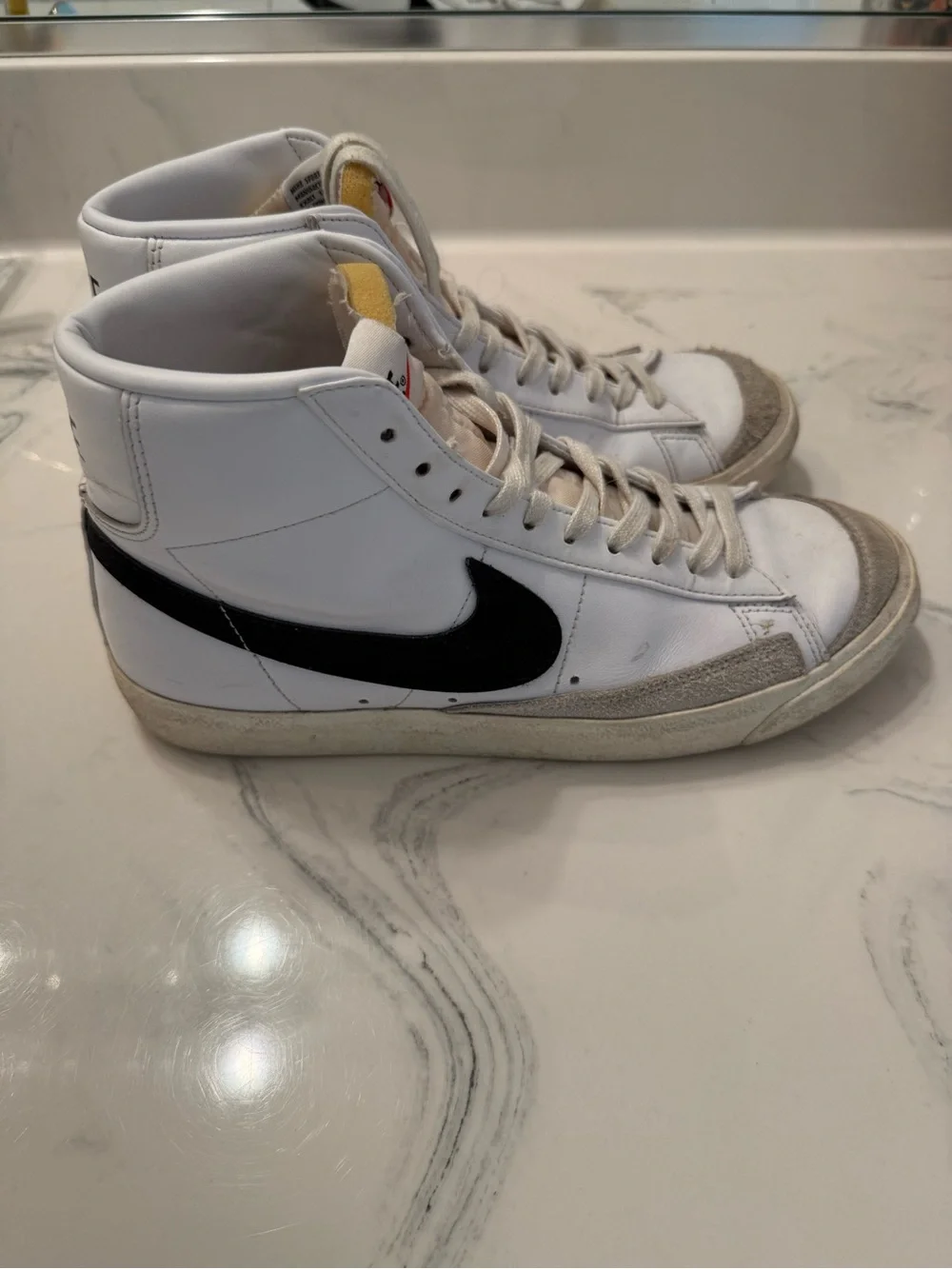 Nike White Sneakers with Black Swoosh and Red Nail Accent